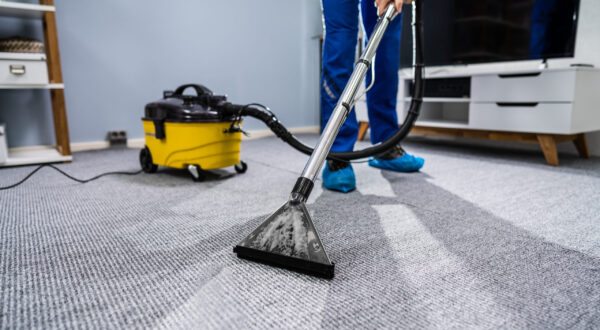 Photo Of Janitor Cleaning Carpet With Vacuum Cleaner